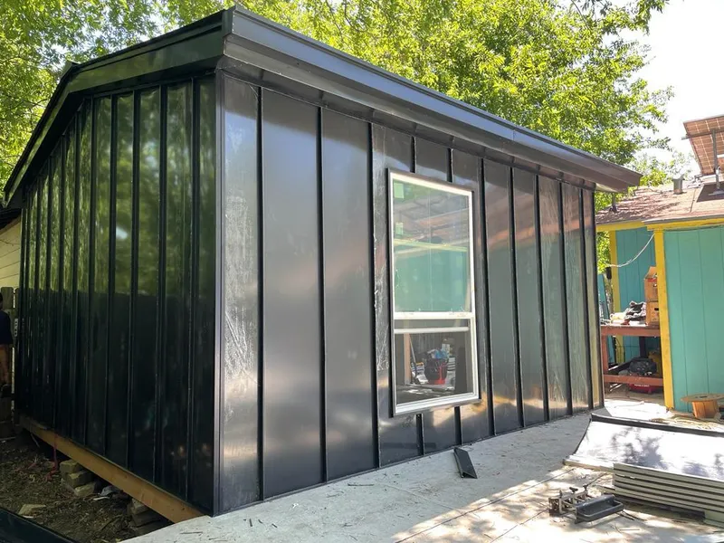 Black standing seam metal wall panels for Metal Roof Installation in Forest